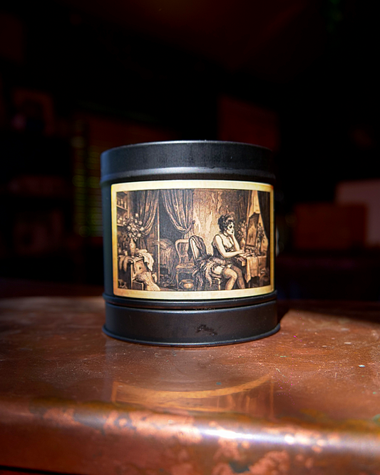 Parisian Boudoir candle in a matte black tin, lid on, with an etched dressing-room label — Wayward
