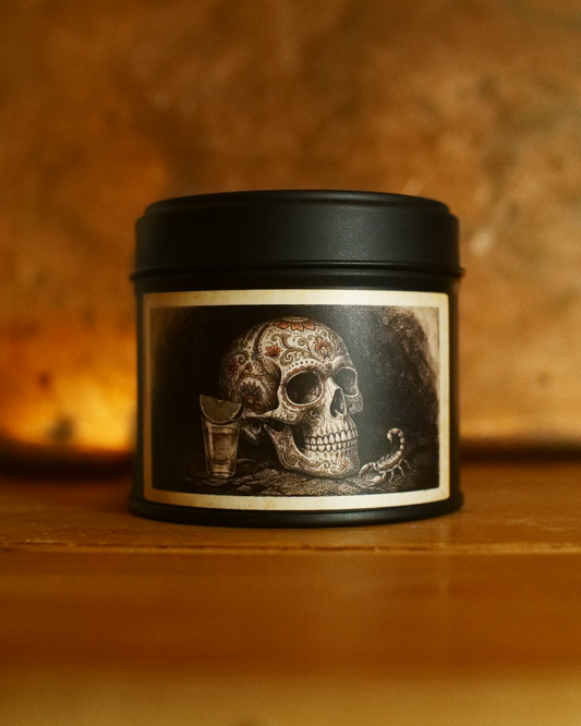 Mexican Tequila Bar candle in a matte black tin, lid on, with an etched label of a decorated calavera beside a tequila shot and lime — Wayward