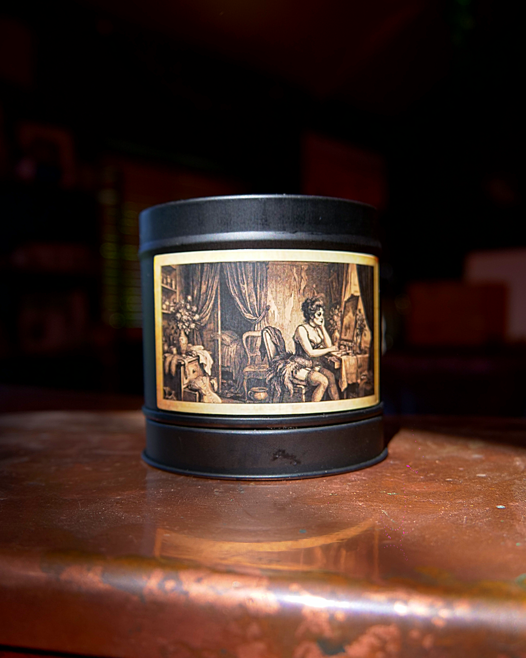Parisian Boudoir candle in a matte black tin, lid on, with an etched dressing-room label — Wayward
