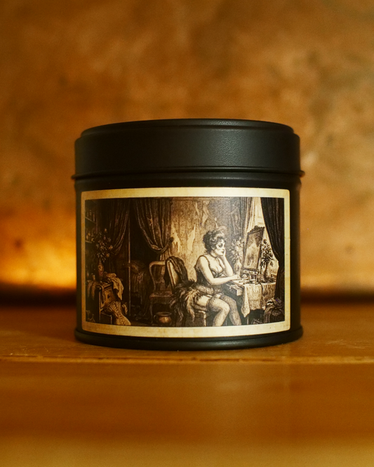 Parisian Boudoir candle in a matte black tin, lid on, with an etched dressing-room label — Wayward