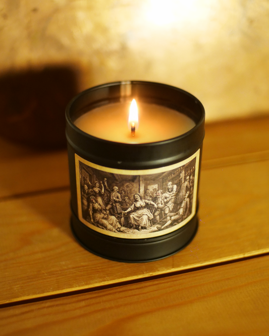 Victorian Gin House candle burning above a gold-bordered etched label of a crowded 18th-century tavern — Wayward