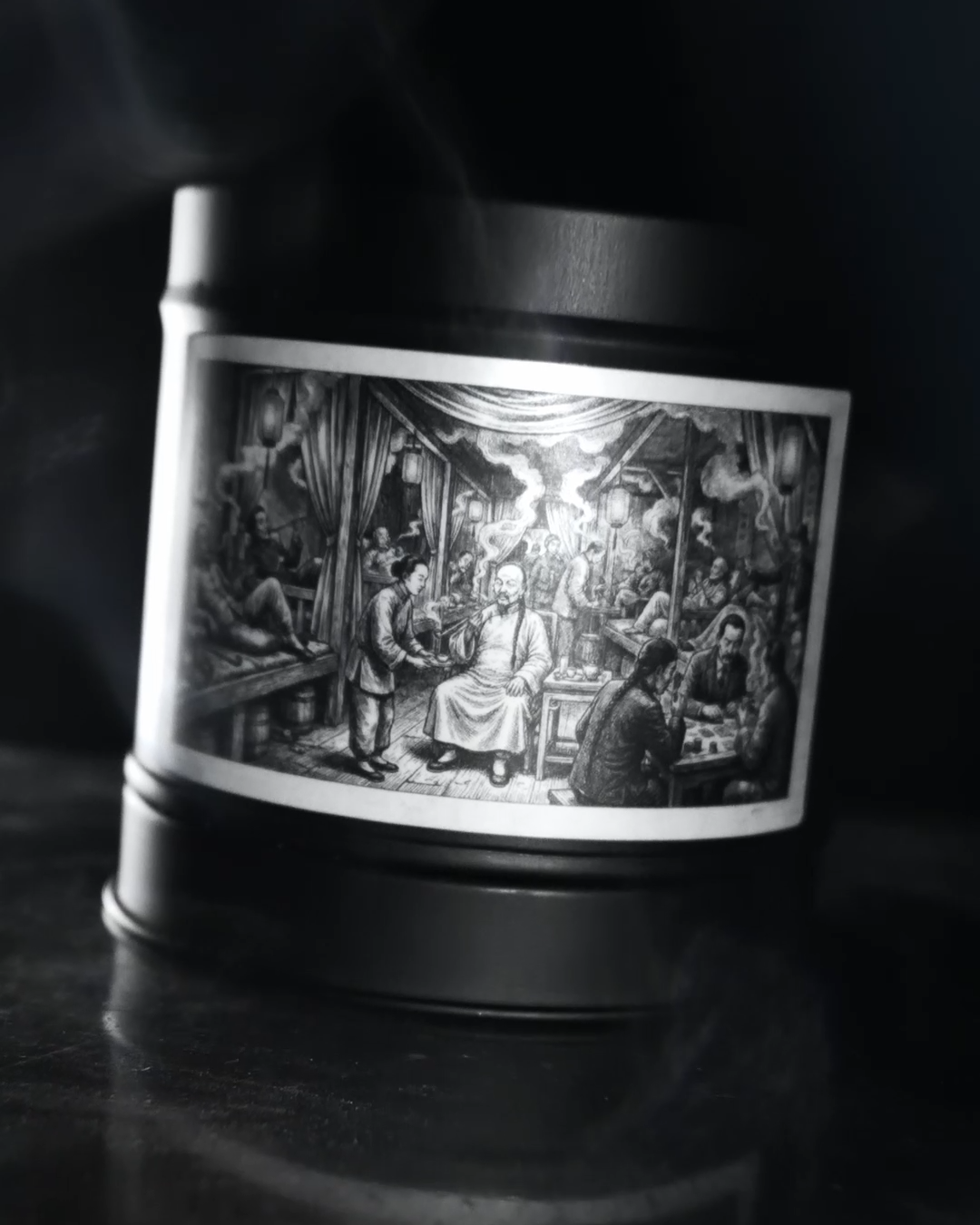 Black-and-white advert still: a Wayward candle tin, smoke drifting above it, the etched label lit in the dark