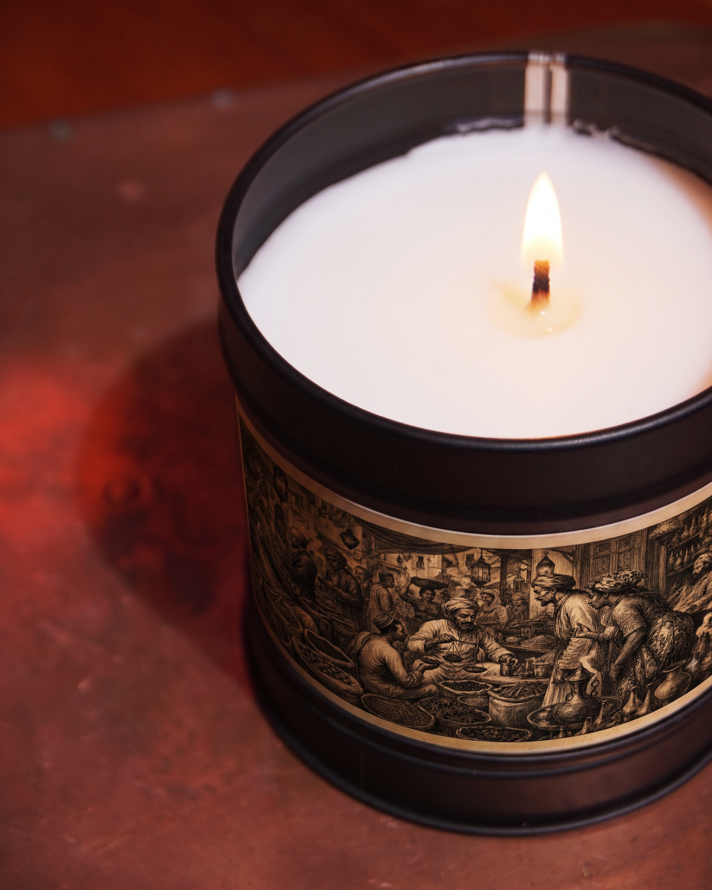 Zanzibar Spice Bazaar candle burning, close on the etched market label with brass scales and spice baskets — Wayward